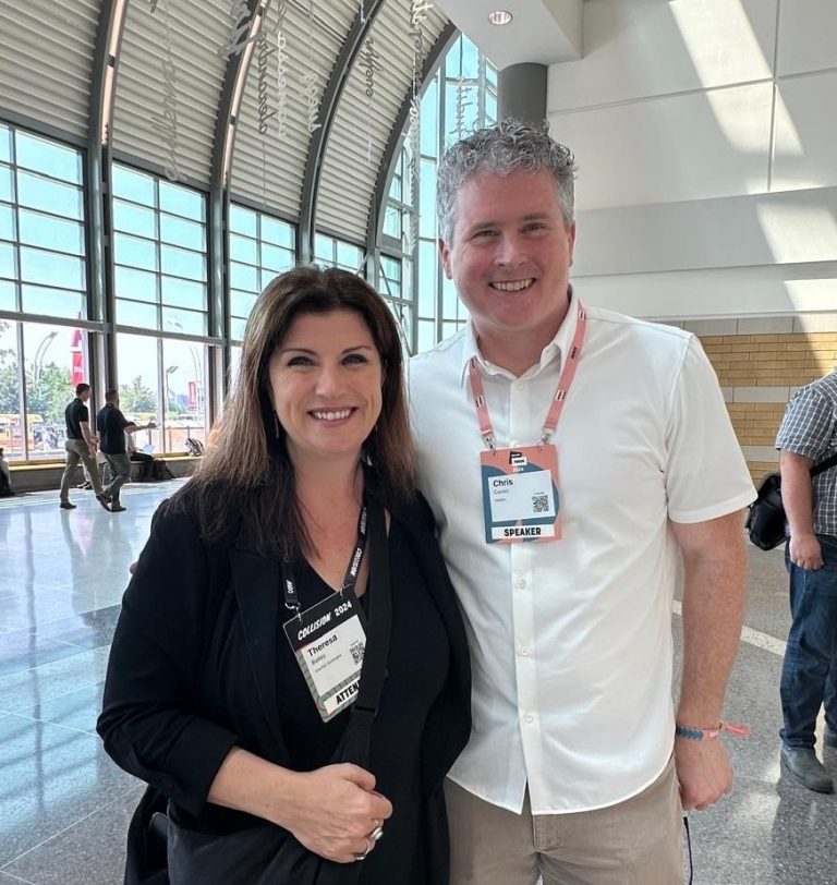 Hasbro CEO Chris Cocks stands with Starfish Synergies CEO Theresa Bailey at the Collision Conference